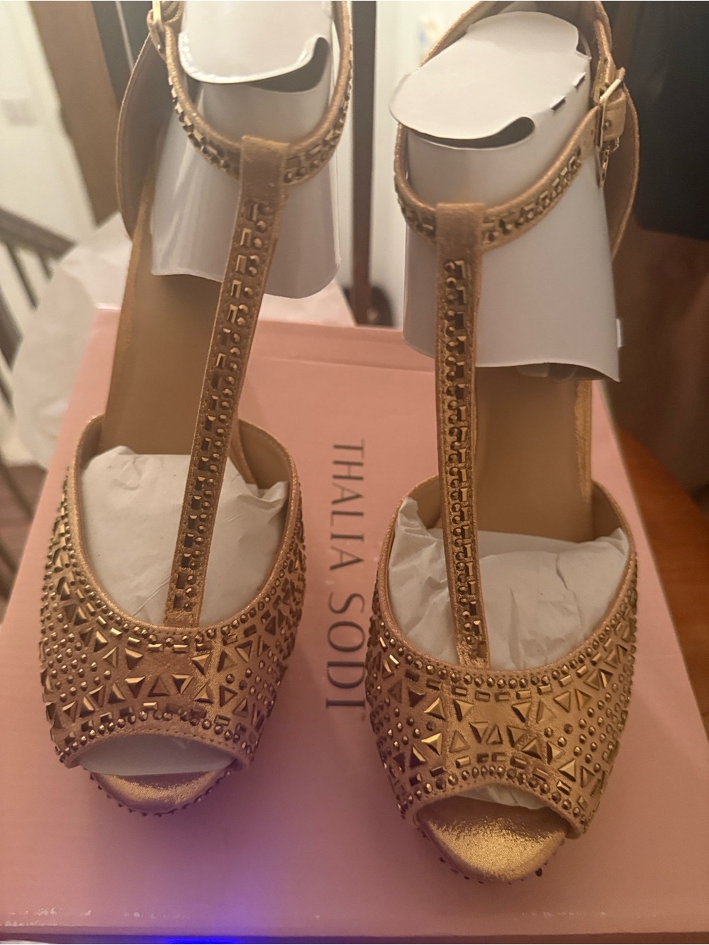 Thalia Sodi woman’s gold studded heels